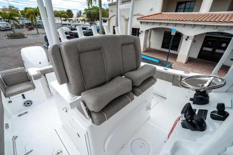 Slide: The Image of 2025 Sea Hunt Gamefish 28 CB boat interior with helm and seating. - 30
