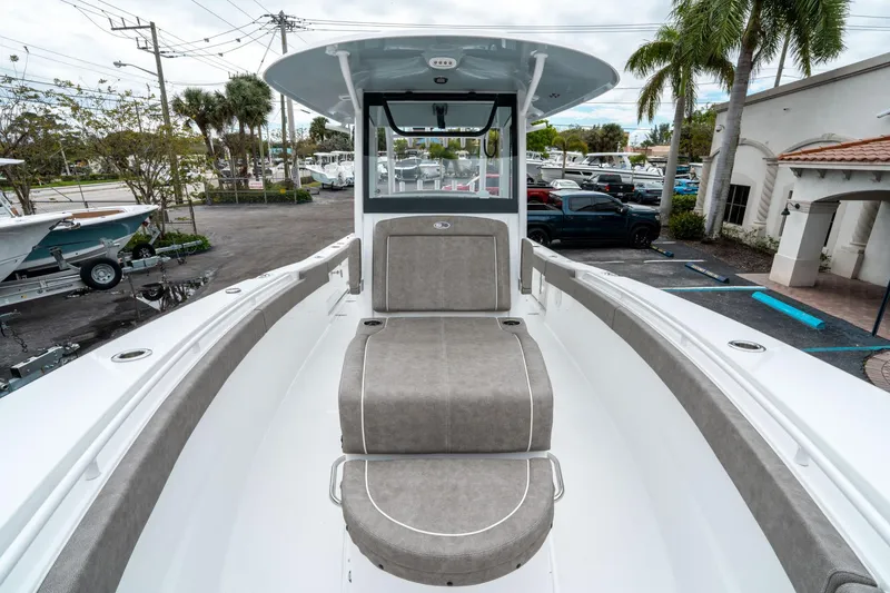 Slide: The Image of 2025 Sea Hunt Gamefish 28 CB boat interior with cushioned seating and modern design. - 38