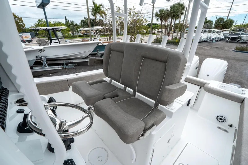 Slide: The Image of 2025 Sea Hunt Gamefish 28 CB boat interior with dual seats and steering wheel. - 28