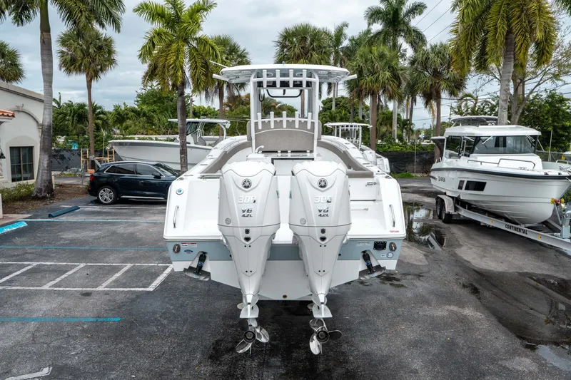 Slide: The Image of 2025 Sea Hunt Gamefish 28 CB with dual engines in a marina setting. - 3