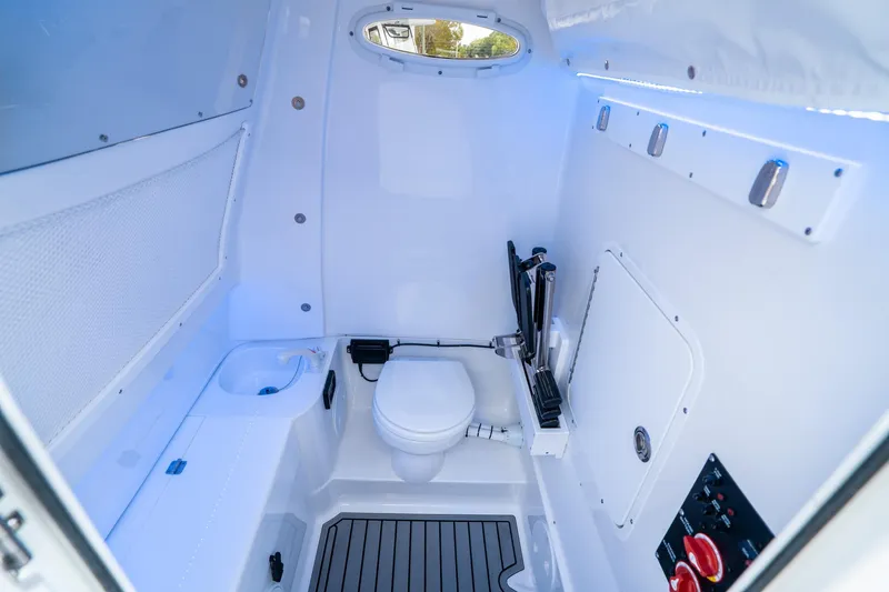 Slide: The Image of Interior of 2025 Sea Hunt Gamefish 28 CB boat, featuring a compact marine toilet. - 33