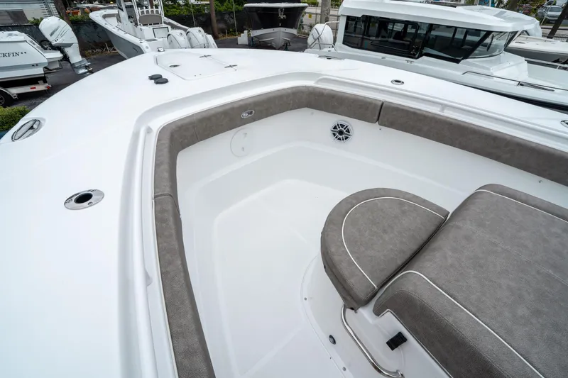 Slide: The Image of 2025 Sea Hunt Gamefish 28 CB boat interior with cushioned seating and sleek design. - 37