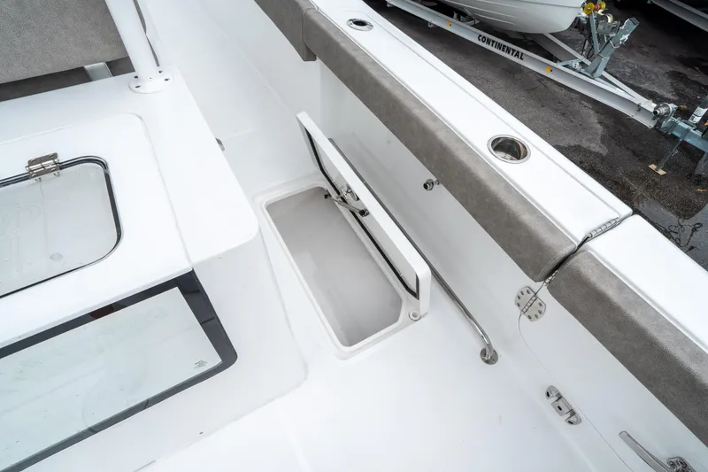 Slide: The Image of 2025 Sea Hunt Gamefish 28 CB boat interior with storage compartment and seating. - 20