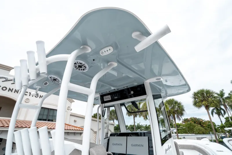 Slide: The Image of 2025 Sea Hunt Gamefish 28 CB boat with T-top and rod holders, featuring Garmin electronics. - 23