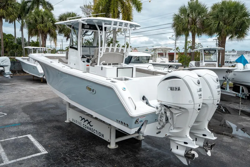 Slide: The Image of 2025 Sea Hunt Gamefish 28 CB boat with twin Yamaha engines, displayed outdoors. - 4