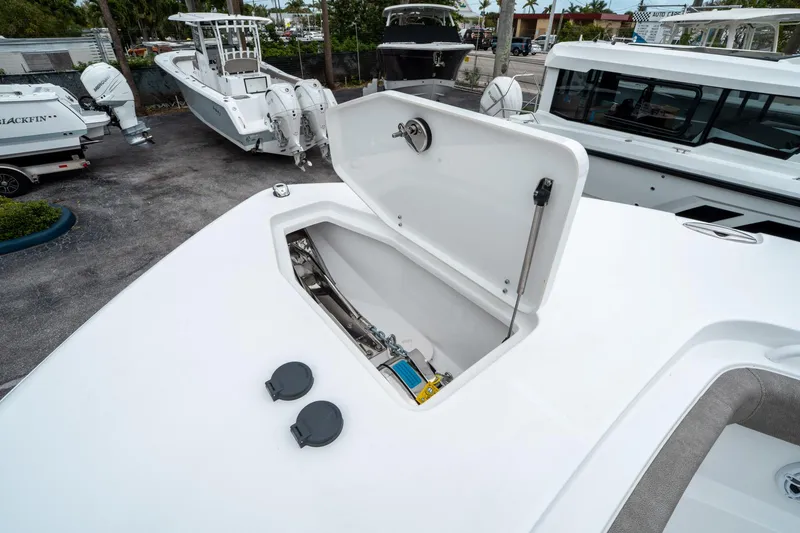 Slide: The Image of 2025 Sea Hunt Gamefish 28 CB boat with open storage compartment on deck. - 41
