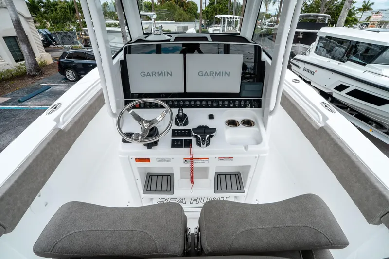 Slide: The Image of 2025 Sea Hunt Gamefish 28 CB helm with dual Garmin displays and modern controls. - 25
