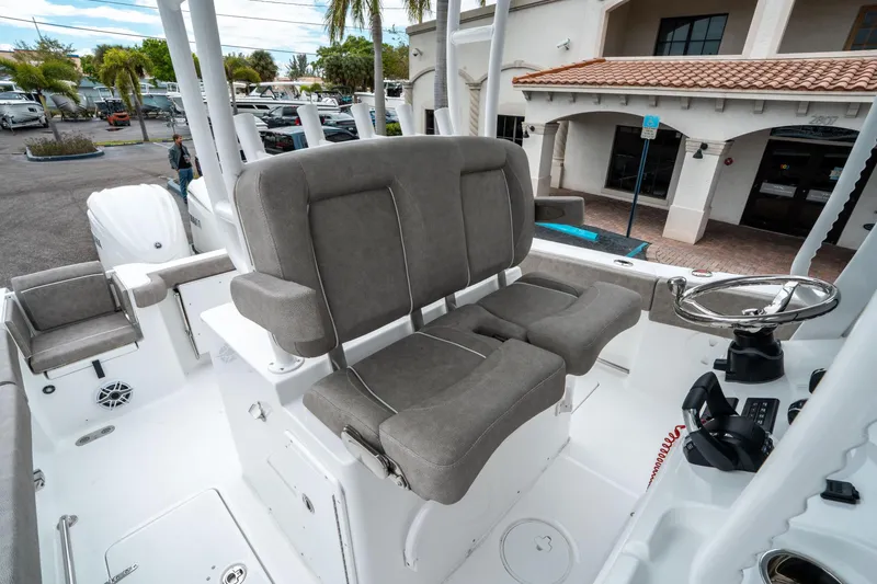 Slide: The Image of 2025 Sea Hunt Gamefish 28 CB boat interior with dual helm seats and steering wheel. - 29