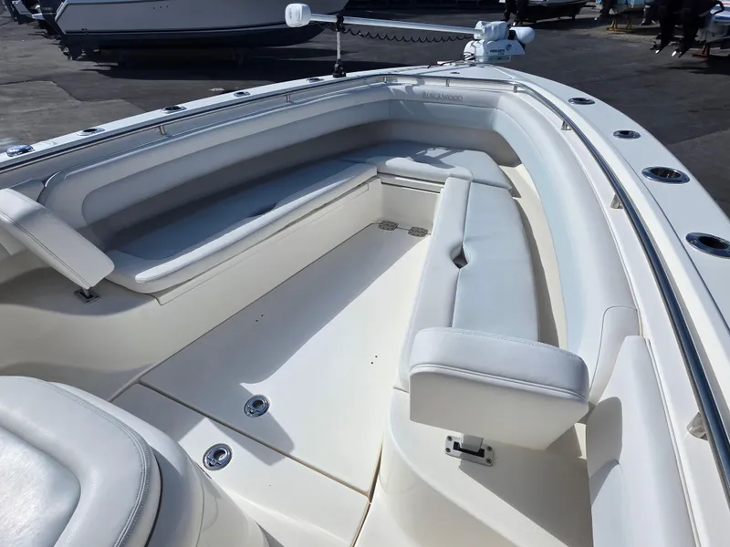 Slide: The Image of 2021 Blackwood 27 boat interior with white cushioned seating and sleek design. - 11