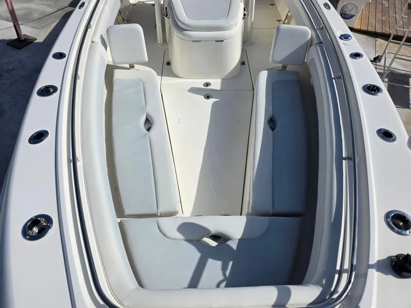 Slide: The Image of 2021 Blackwood 27 boat interior with white cushioned seating and sleek design. - 12