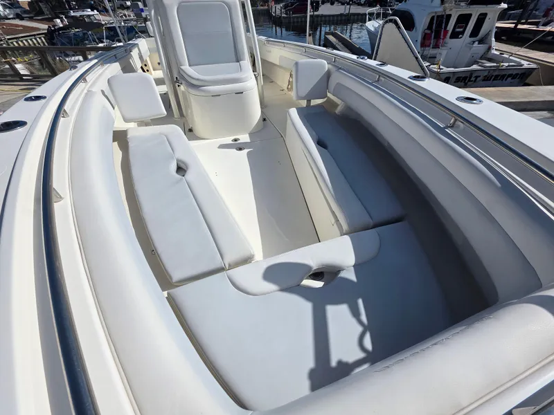 Slide: The Image of 2021 Blackwood 27 boat interior with white cushioned seating and sleek design. - 13