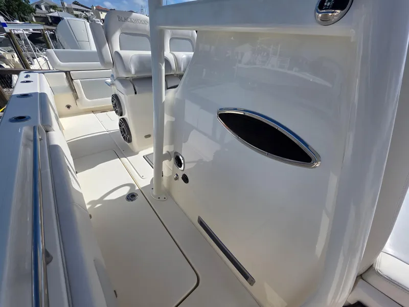 Slide: The Image of 2021 Blackwood 27 boat interior with white seating and sleek design elements. - 17