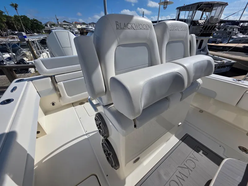Slide: The Image of Luxury seating on a 2021 Blackwood 27 boat, featuring plush white upholstery. - 18