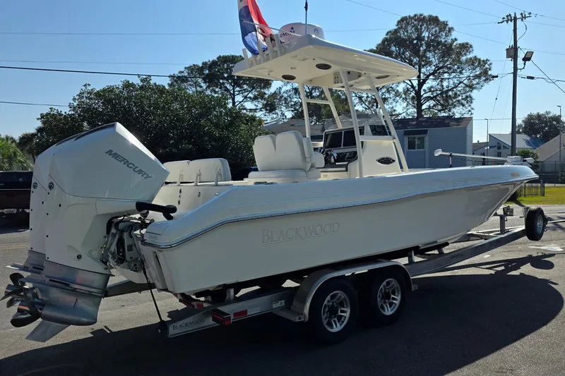 Slide: The Image of 2021 Blackwood 27 boat on trailer, for sale, parked outdoors. - 2