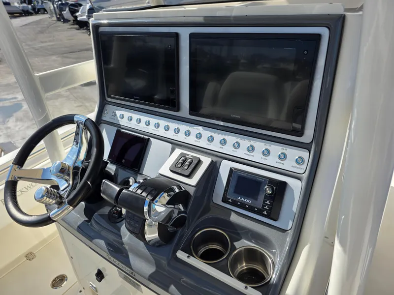 Slide: The Image of Control panel of a 2021 Blackwood 27 boat with dual screens and steering wheel. - 20