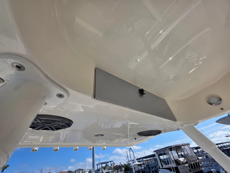 Slide: The Image of 2021 Blackwood 27 boat interior ceiling with speakers and lighting, marina background. - 22
