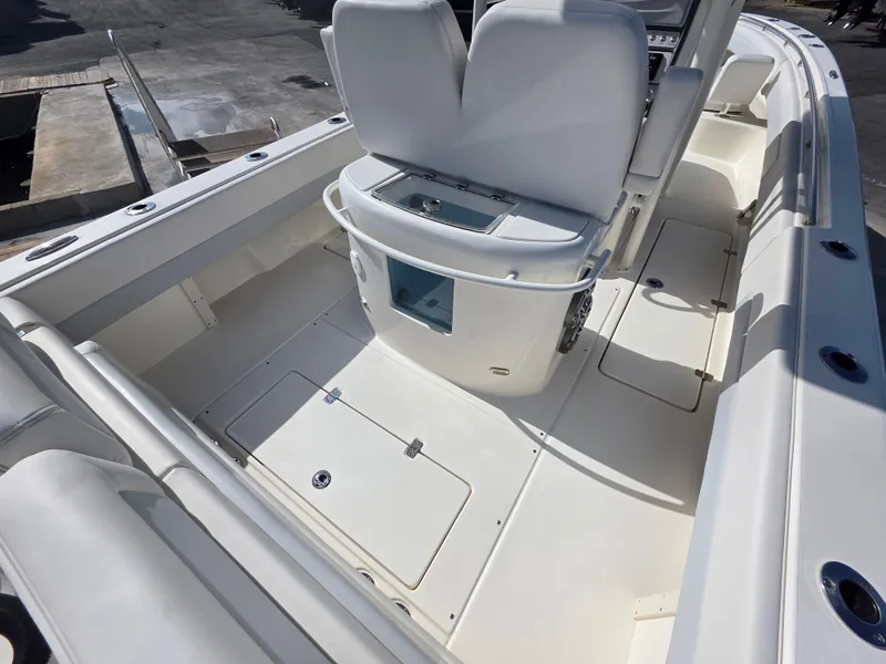 Slide: The Image of 2021 Blackwood 27 boat interior with white seating and storage compartments. - 27