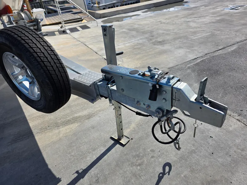 Slide: The Image of Trailer hitch and wheel assembly on a Blackwood 27, 2021 model, parked on concrete. - 29