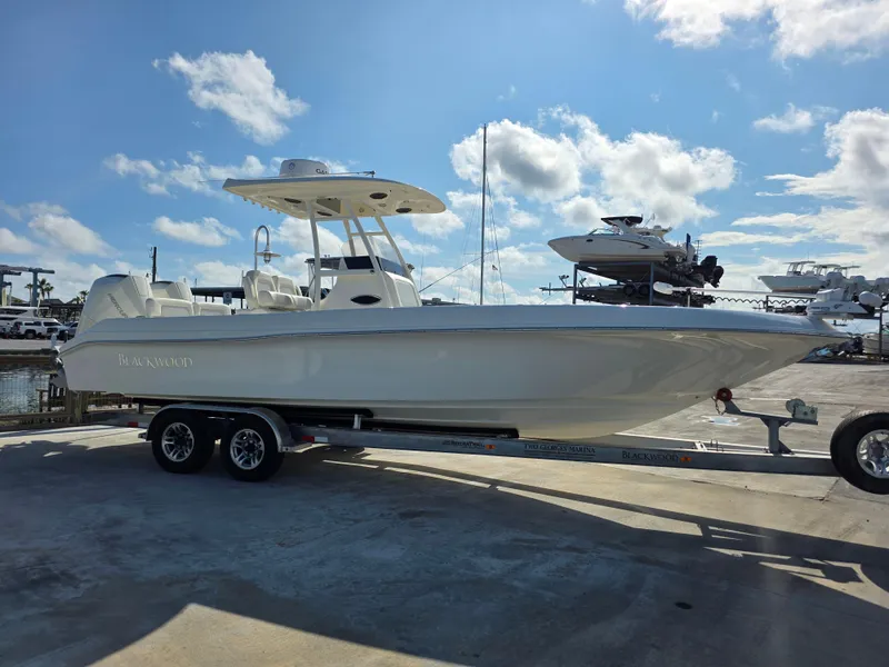 Slide: The Image of 2021 Blackwood 27 boat on trailer under blue sky with clouds. - 7