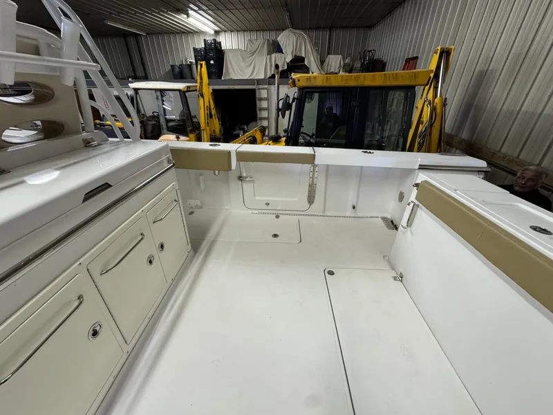 Slide: The Image of 2017 Southport 33 FE boat interior in storage, featuring spacious deck and cabinetry. - 11