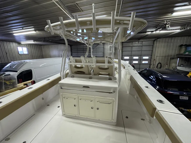 Slide: The Image of 2017 Southport 33 FE boat interior in a garage, showcasing helm and seating area. - 12