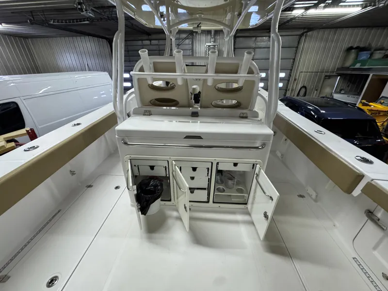 Slide: The Image of 2017 Southport 33 FE boat interior with open storage compartments in a garage setting. - 13