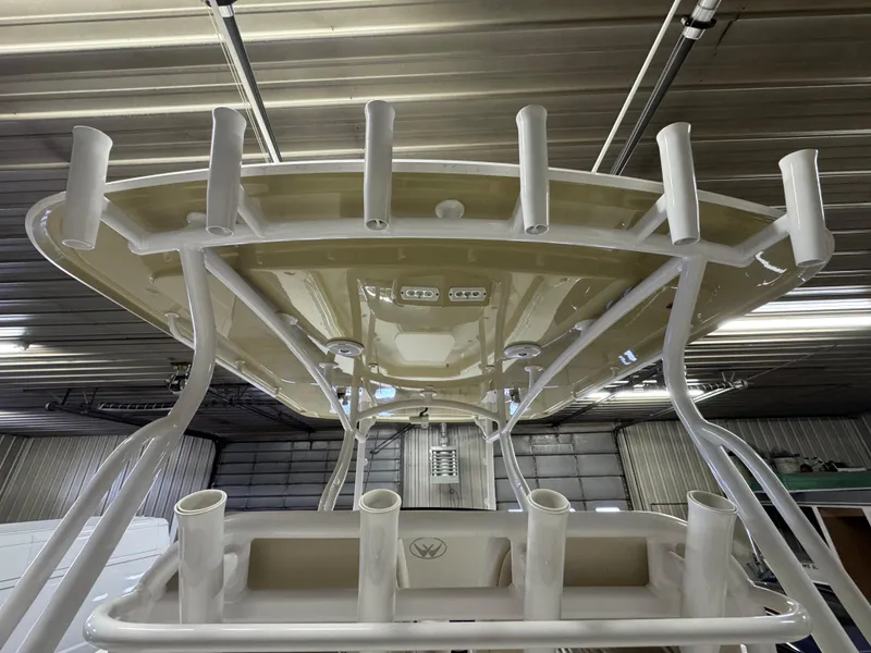 Slide: The Image of 2017 Southport 33 FE boat's T-top with rod holders in a garage setting. - 15
