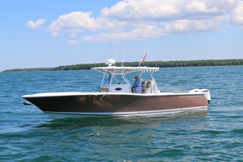 Slide: The Image of 2017 Southport 33 FE boat cruising on a sunny day with clear skies. - 2