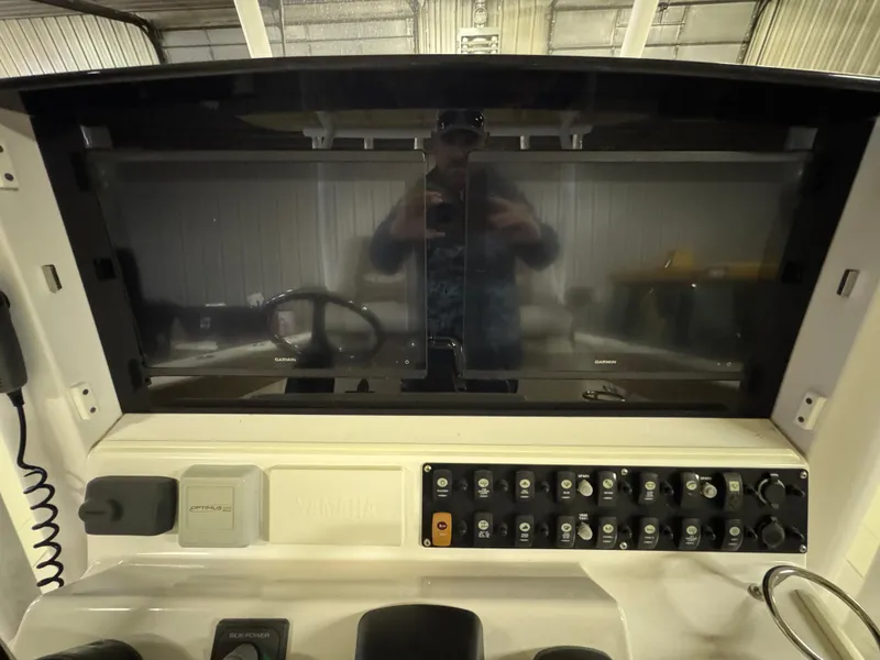 Slide: The Image of 2017 Southport 33 FE boat dashboard with control panel and steering wheel. - 21