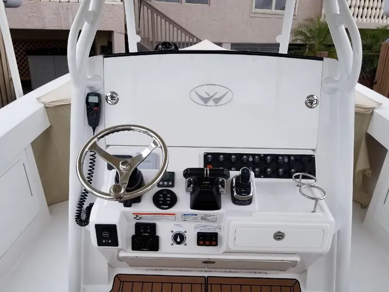 Slide: The Image of 2017 Southport 33 FE boat console with steering wheel and controls. - 22