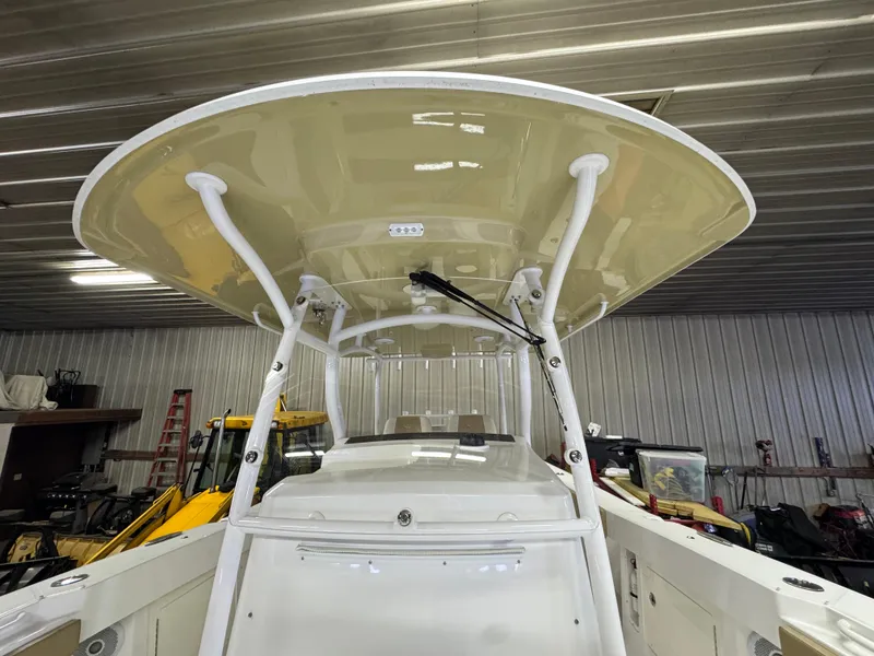 Slide: The Image of 2017 Southport 33 FE boat in storage, featuring a sturdy T-top and sleek design. - 25