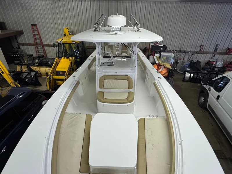 Slide: The Image of 2017 Southport 33 FE boat with spacious seating and modern design in a storage facility. - 29