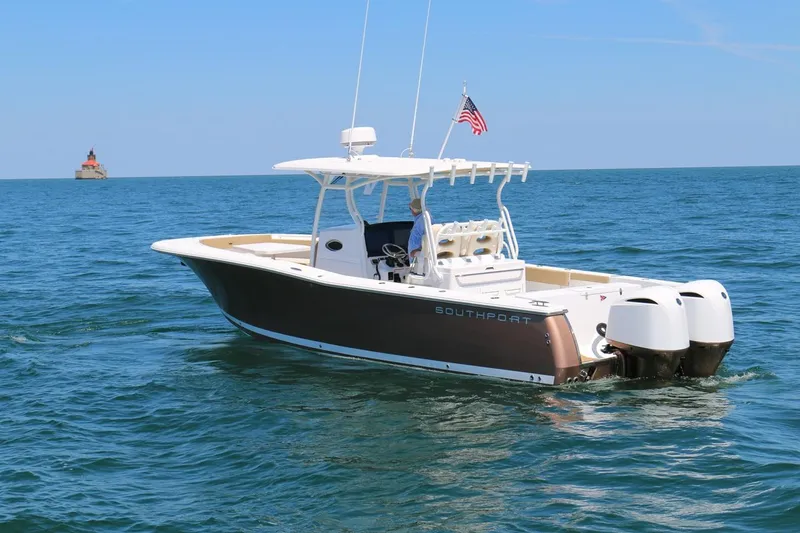 Slide: The Image of 2017 Southport 33 FE boat on open water with American flag. - 3