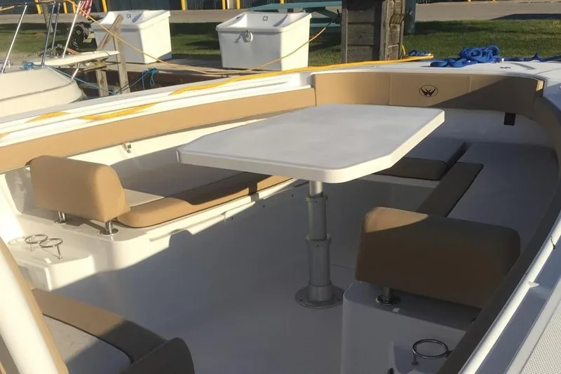 Slide: The Image of 2017 Southport 33 FE boat interior with seating and table setup. - 31