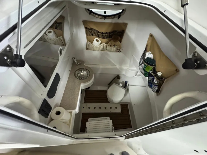 Slide: The Image of 2017 Southport 33 FE boat interior with sink, toilet, and storage compartments. - 32
