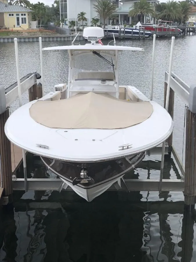 Slide: The Image of 2017 Southport 33 FE boat docked in marina, covered bow, calm water setting. - 34