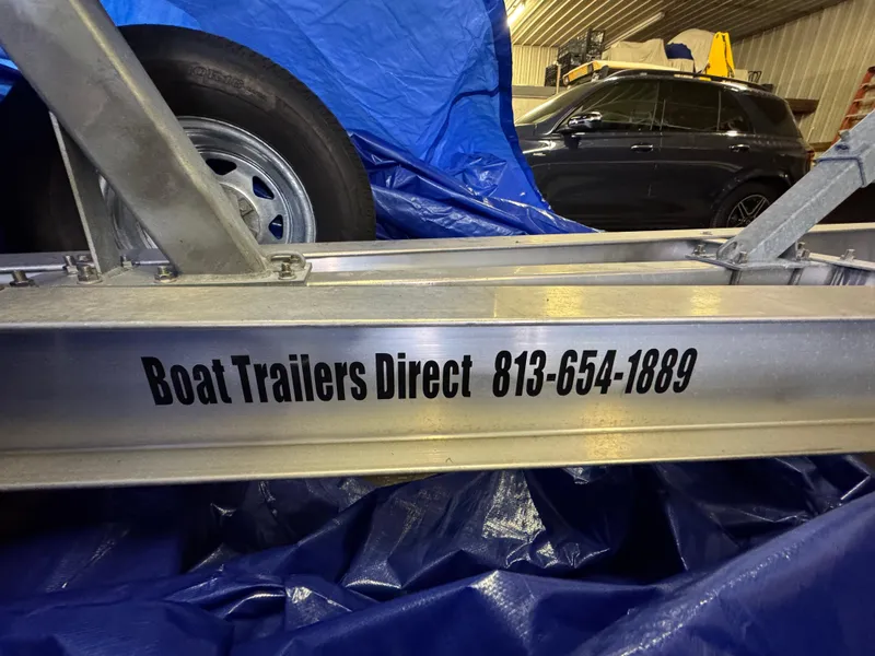 Slide: The Image of Boat trailer with contact info, Southport 33 FE, 2017 model, in a garage setting. - 36