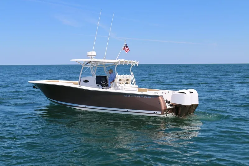 Slide: The Image of 2017 Southport 33 FE boat on open water with American flag. - 4