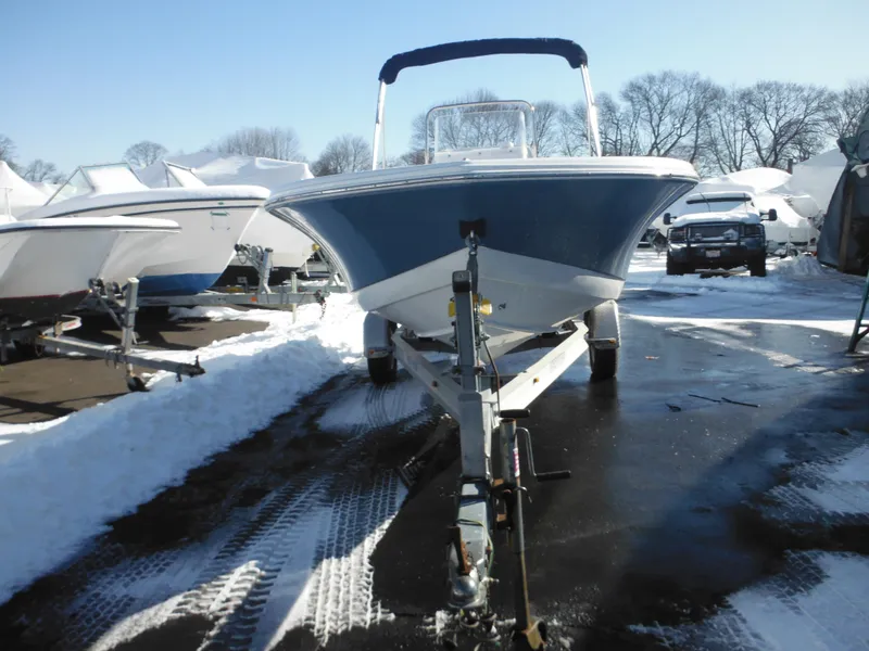 Slide: The Image of 2025 Tidewater 180 CC Adventure boat on trailer in snowy marina. - 11