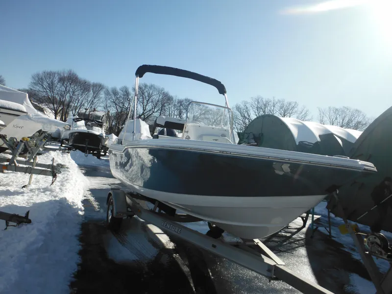 Slide: The Image of 2025 Tidewater 180 CC Adventure boat on trailer in snowy outdoor setting. - 12