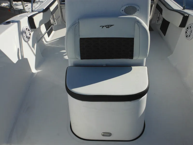 Slide: The Image of 2025 Tidewater 180 CC Adventure boat interior with cushioned seating and storage. - 16