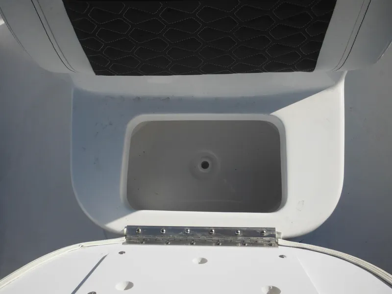 Slide: The Image of 2025 Tidewater 180 CC Adventure boat storage compartment with open lid. - 17