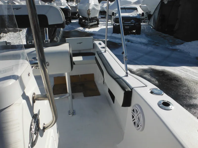 Slide: The Image of 2025 Tidewater 180 CC Adventure boat interior with seating and storage, parked in a snowy area. - 20