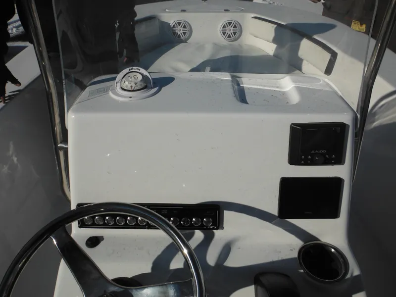 Slide: The Image of 2025 Tidewater 180 CC Adventure boat dashboard with steering wheel and controls. - 25
