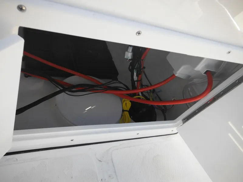 Slide: The Image of 2025 Tidewater 180 CC Adventure boat wiring compartment with cables and connections. - 29