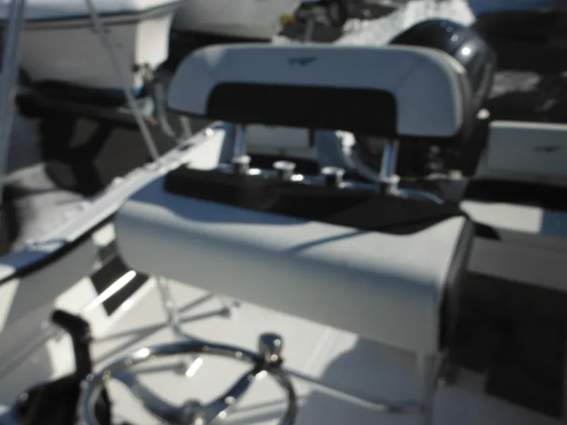 Slide: The Image of 2025 Tidewater 180 CC Adventure boat interior with steering wheel and seating. - 30