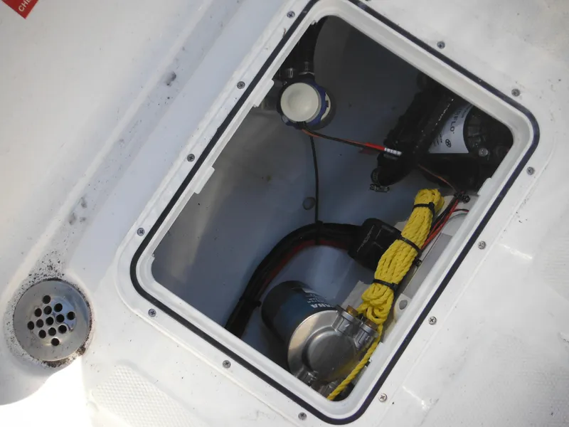Slide: The Image of Storage compartment of 2025 Tidewater 180 CC Adventure boat, showing equipment and wiring. - 36
