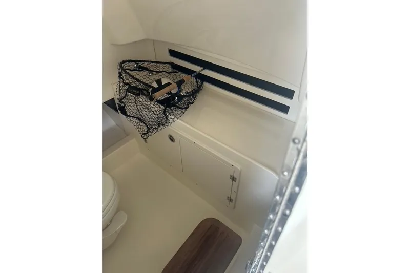 Slide: The Image of Interior of 2016 Boston Whaler 330 Outrage boat with fishing net storage. - 14