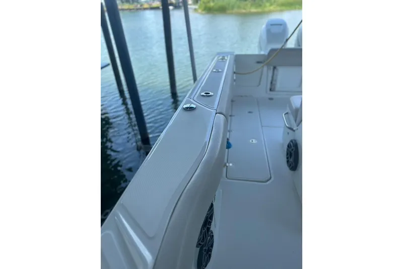 Slide: The Image of 2016 Boston Whaler 330 Outrage boat interior, showcasing sleek design and spacious deck. - 17