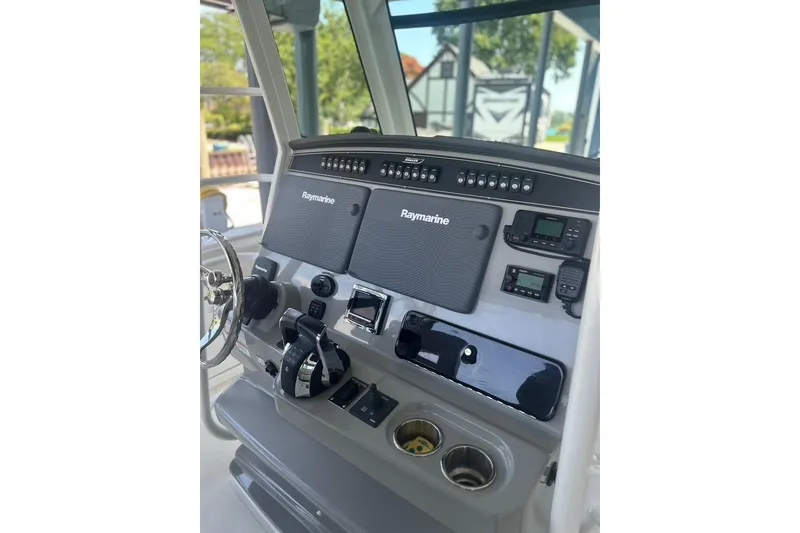 Slide: The Image of 2016 Boston Whaler 330 Outrage helm with Raymarine electronics and control panel. - 18